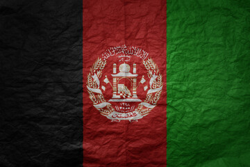 big national flag of afghanistan on a grunge old paper texture background