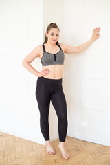 Fototapeta na wymiar woman in sportswear doing fitness at home
