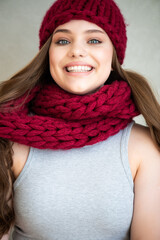 portrait of a beautiful young woman in a knitted hat and scarf