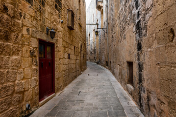 Fototapeta na wymiar Empty street of ancient Roman city Mdina, ancient capital of Malta, fortified medieval town. Popular touristic destination 