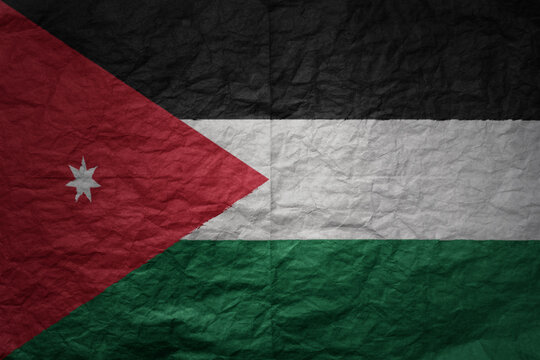 big national flag of jordan on a grunge old paper texture background
