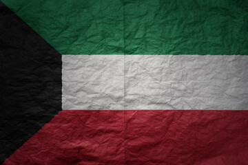 big national flag of kuwait on a grunge old paper texture background