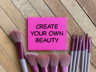Motivational and inspirational wording about beauty. CREATE YOUR OWN BEAUTY written on a notepad.