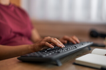 A close-up shot of female hands typing on a keyboard