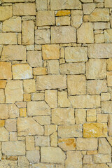 real stone wall made of yellow stone 1