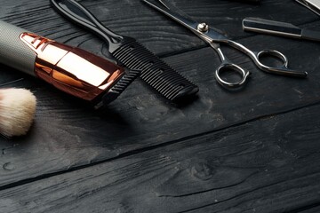 Professional Barber Tools Laid Out Dark Wooden Surface