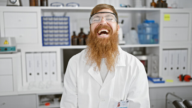 Smiling young redhead scientist, full of confidence, man in lab sporting secure glasses