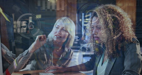 A woman is working on a computer in an office