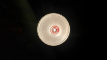 Modern ceiling light or light bulb hanging from ceiling in glass house construction building. Retro lighting decoration.