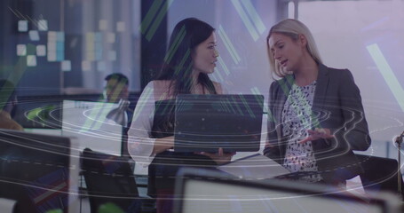 Image of tunnel in seamless pattern over two diverse women discussing over a laptop at office