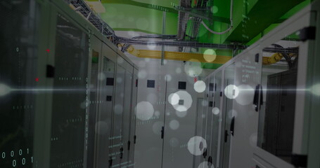 Image of data processing, light trails and white spots floating against computer server room