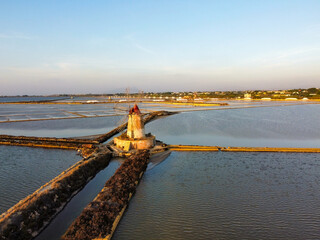 aerial view of the Stagnone salt pans and the ancient windmills at sunset
