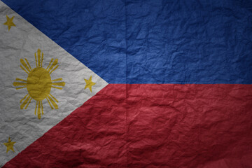 big national flag of philippines on a grunge old paper texture background
