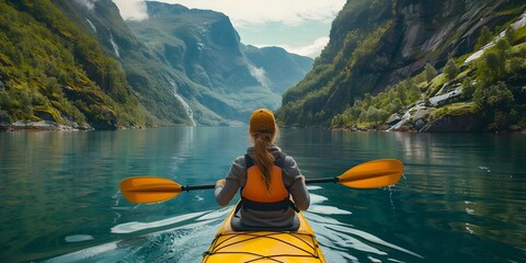 Woman Kayaking Through Pristine Fjords in Majestic Norwegian Landscape