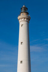 Fototapeta na wymiar A white lighthouse in a sunny day.