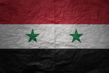 big national flag of syria on a grunge old paper texture background