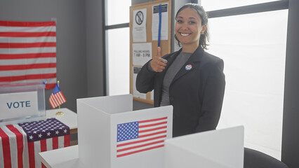 Smiling woman giving thumbs up in a voting booth with american flags at a polling station