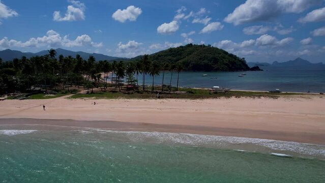 4K Aerial Drone video of Twin beach and Nacpan beach with beautiful sand and palm trees in Calibangbangan, Linapacan, Palawan, Philippines