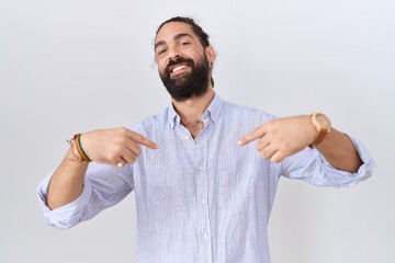 Hispanic man with beard wearing casual shirt looking confident with smile on face, pointing oneself...