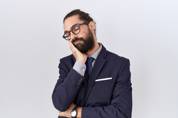 Hispanic man with beard wearing suit and tie thinking looking tired and bored with depression...