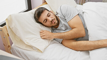 A young hispanic man sleeps peacefully in a comfortable bedroom setting, showcasing a relaxed and cozy atmosphere.