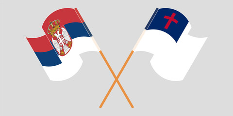 Crossed and waving flags of Serbia and christianity
