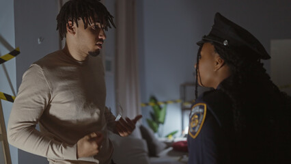 A man and a policewoman engage in a serious conversation indoors, implying a tense investigative...