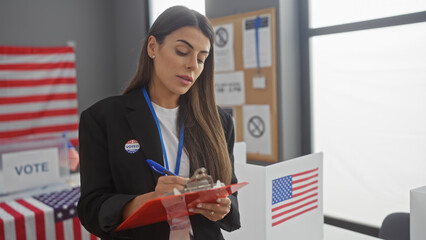 Hispanic woman wearing 'i voted' sticker takes notes at a us electoral polling station with...