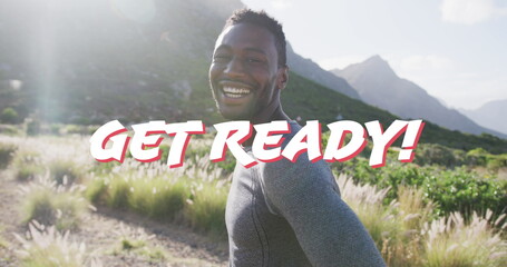 Image of the words get ready in white over happy man hiking in mountains - Powered by Adobe