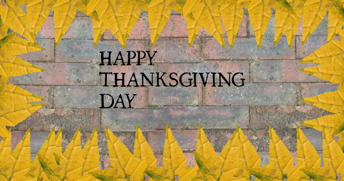 Image of happy thanksgiving day text over bricks with autumn leaves