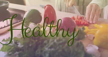 Image of healthy text in green letters over caucasian woman cutting vegetables