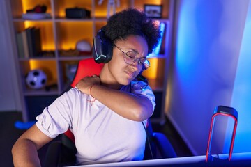 African american woman streamer stressed suffering for backache at gaming room - obrazy, fototapety, plakaty