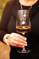 Crop woman with white wine outdoors