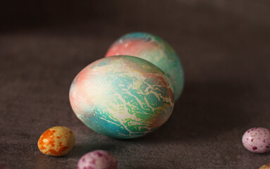 Colored chicken eggs on a dark background for Easter holiday