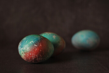 Colored chicken eggs on a dark background for Easter holiday
