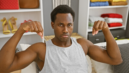 African man disapproving with thumbs down in a modern bedroom - obrazy, fototapety, plakaty