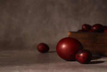Easter red chicken and quail eggs on a dark background
