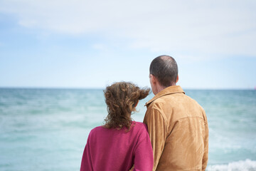 Couple looking at the ocean in the beach