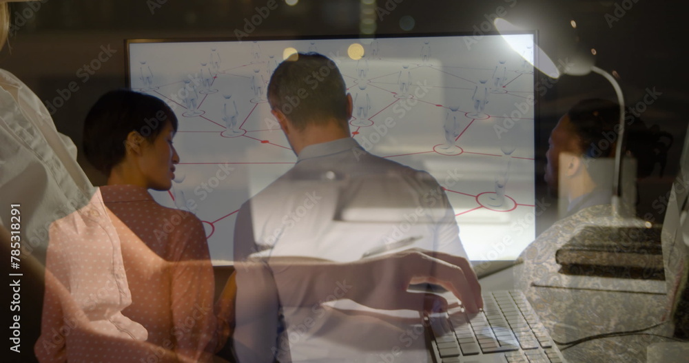 Wall mural Image of diverse business people talking over caucasian businesswoman using computer