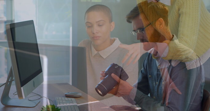 Image of diverse business people talking over businessman using camera