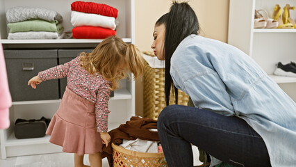 A mother and daughter engage in tidying a room, reflecting family, love, and togetherness among...