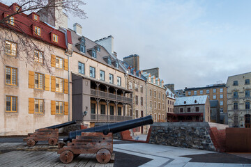 Cannons on the Royal Battery, with historic buildings on Place de Paris in the Petit-Champlain...