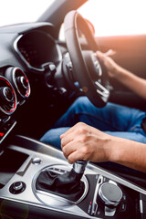 Hand of driver holding steering wheel of car, modern car ventilation system and air conditioning in...