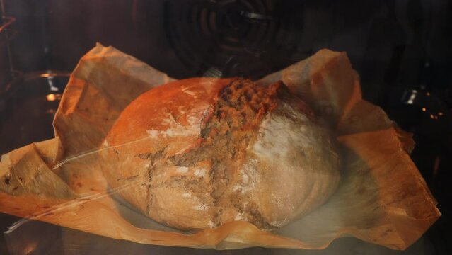 A timelapse of artisan bread in the oven. Preparation of homemade sourdough bread.