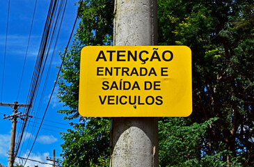 Warning sign in portuguese informing "Attention, entry and exit of vehicles", Ribeirao Preto, Sao Paulo, Brazil