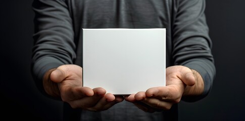 A man holding white box for product presentation.
