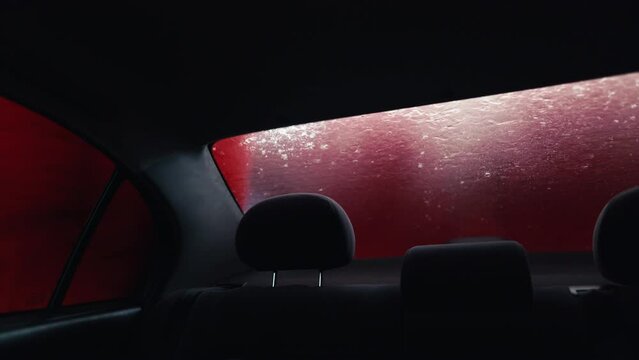 Soapy Symphony: Immerse yourself in the soothing rhythm of an automatic car wash as your vehicle is lathered in foam, captured from inside to reveal the beauty of the cleansing ritual.
