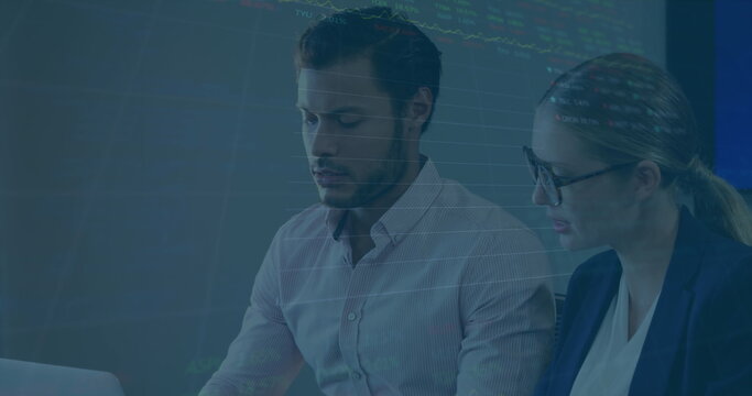 Image of stock market data processing over caucasian businessman and businesswoman discussing