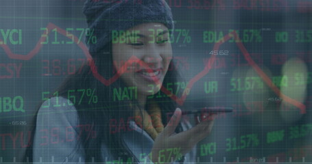 Image of financial data processing over businesswoman using smartphone