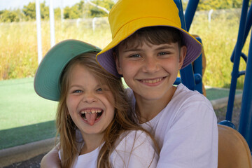 Cheerful boy and girl in hats